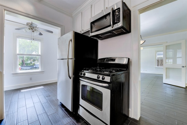 2027 Huldy St, Houston, TX 77019 - kitchen with stainless steel appliances, crown molding, white cabinets, and ceiling fan