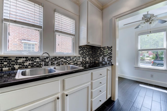 2027 Huldy St, Houston, TX 77019 - kitchen featuring tasteful backsplash, dark countertops, ornamental molding, white cabinets, and ceiling fan