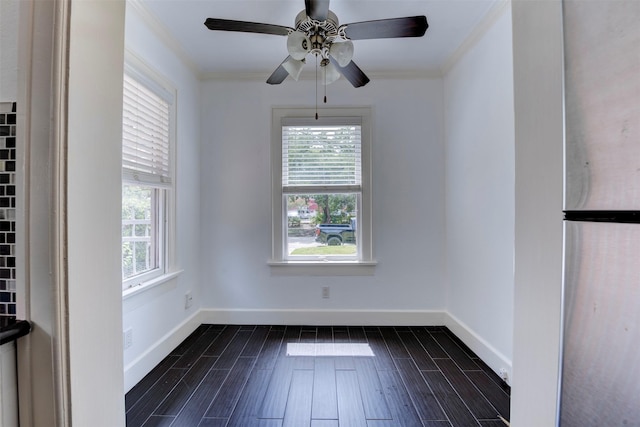 2027 Huldy St, Houston, TX 77019 - spare room featuring plenty of natural light, crown molding, dark wood finished floors, and a ceiling fan