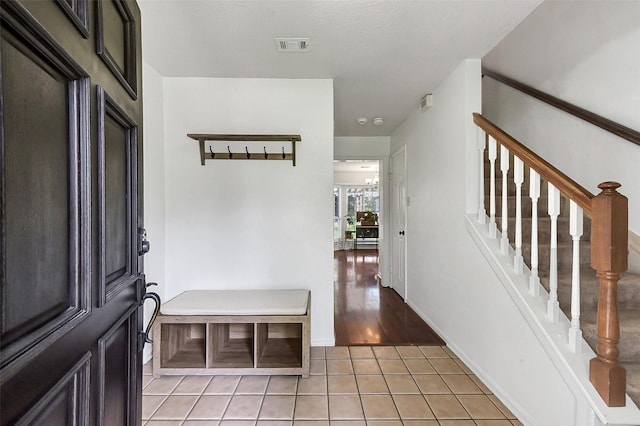 17214 Palm Falls Ct, Houston, TX 77095 - foyer featuring light tile patterned floors and stairs