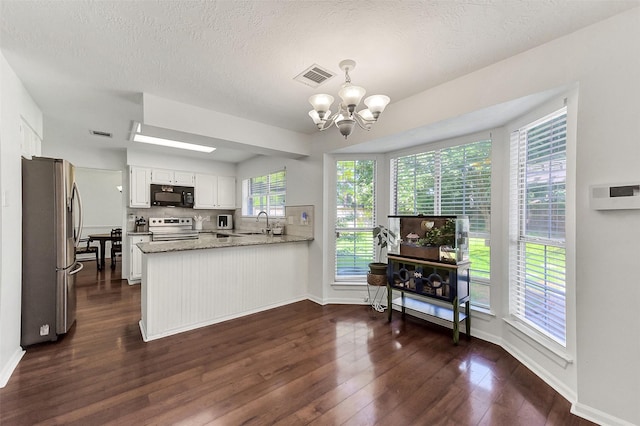 17214 Palm Falls Ct, Houston, TX 77095 - kitchen featuring stainless steel appliances, a chandelier, a peninsula, white cabinets, and dark wood-style floors