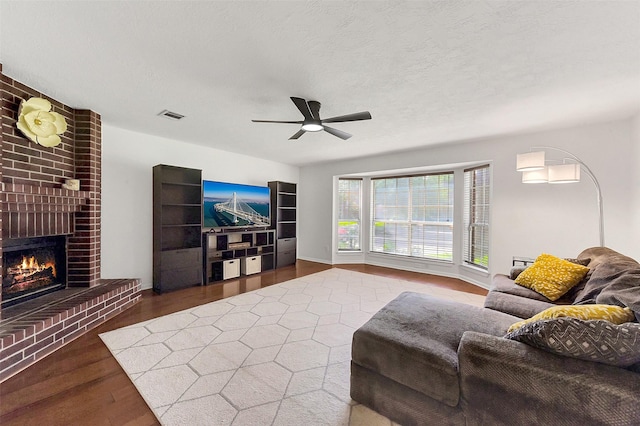 17214 Palm Falls Ct, Houston, TX 77095 - living room with wood finished floors, ceiling fan, and a brick fireplace