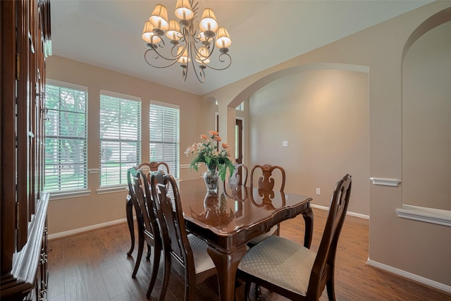 21619 Oakcreek Ct, Katy, TX 77450 - dining area featuring arched walkways, healthy amount of natural light, and wood finished floors