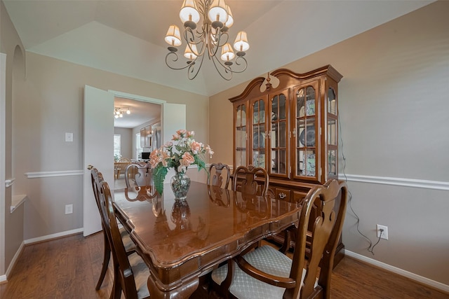 21619 Oakcreek Ct, Katy, TX 77450 - dining room with dark wood-style flooring, a chandelier, arched walkways, and lofted ceiling