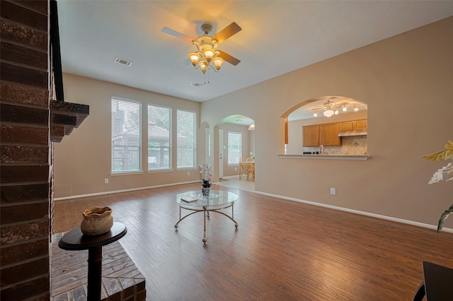 21619 Oakcreek Ct, Katy, TX 77450 - living room with a ceiling fan, arched walkways, and wood finished floors