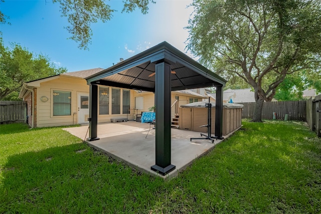 21619 Oakcreek Ct, Katy, TX 77450 - back of house with a gazebo, a patio area, a fenced backyard, and a hot tub