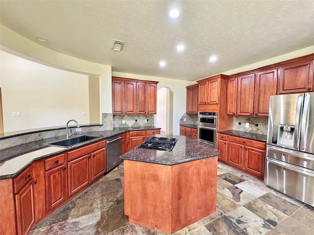 8110 Hideaway Run Way, Spring, TX 77389 - kitchen with arched walkways, stainless steel appliances, a center island, decorative backsplash, and recessed lighting