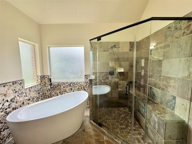 8110 Hideaway Run Way, Spring, TX 77389 - bathroom featuring a freestanding bath, tile walls, a shower stall, and wainscoting