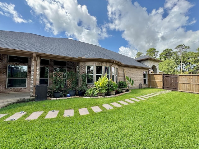 8110 Hideaway Run Way, Spring, TX 77389 - rear view of property featuring a gate, a shingled roof, and brick siding
