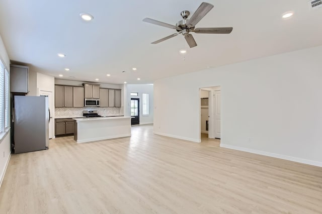 19367 Poppy Village Cir, Magnolia, TX 77355 - unfurnished living room with light wood-type flooring, recessed lighting, and a ceiling fan