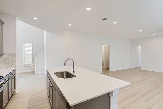 19367 Poppy Village Cir, Magnolia, TX 77355 - kitchen featuring stainless steel appliances, light wood finished floors, light countertops, a center island with sink, and recessed lighting