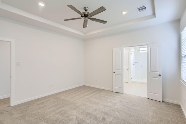 19367 Poppy Village Cir, Magnolia, TX 77355 - unfurnished bedroom with light carpet, a raised ceiling, and recessed lighting