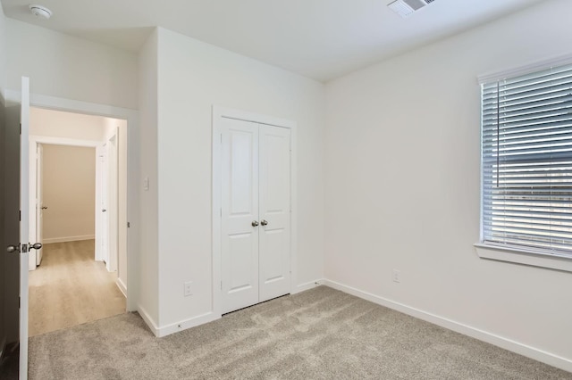 19367 Poppy Village Cir, Magnolia, TX 77355 - unfurnished bedroom featuring light carpet and a closet