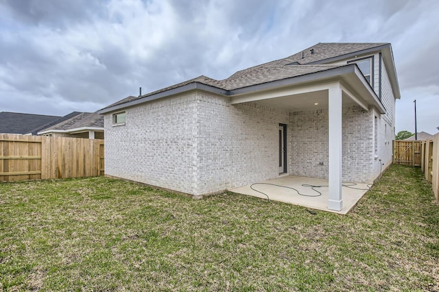 19367 Poppy Village Cir, Magnolia, TX 77355 - rear view of house featuring a patio, brick siding, a fenced backyard, and a shingled roof