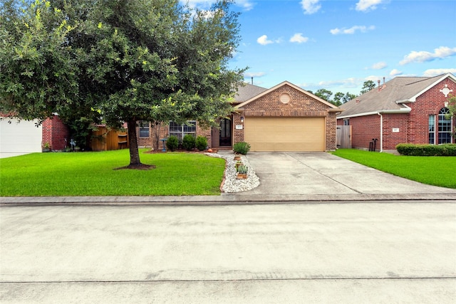 423 Carson Ridge Dr, Spring, TX 77386 - view of front of home featuring brick siding, a garage, driveway, and a front lawn