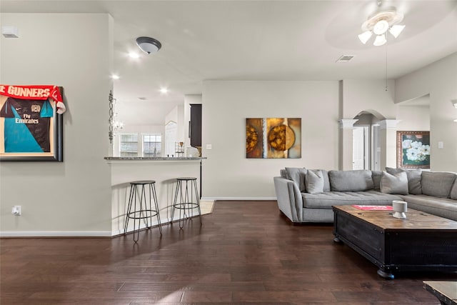 423 Carson Ridge Dr, Spring, TX 77386 - living area with ceiling fan, ornate columns, wood finished floors, and arched walkways