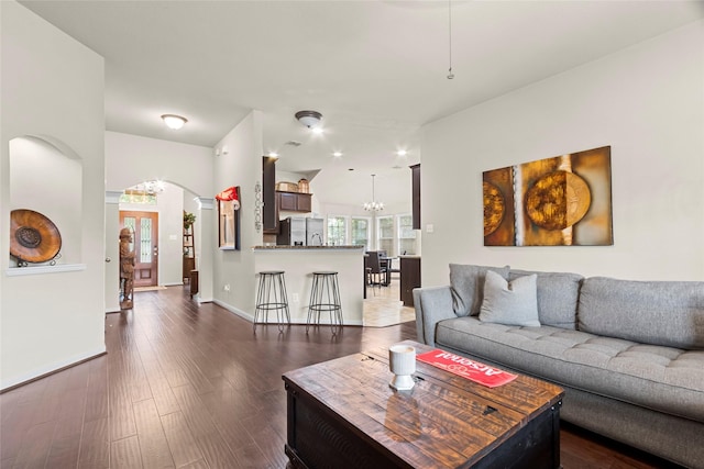 423 Carson Ridge Dr, Spring, TX 77386 - living area with arched walkways, dark wood-type flooring, and a chandelier