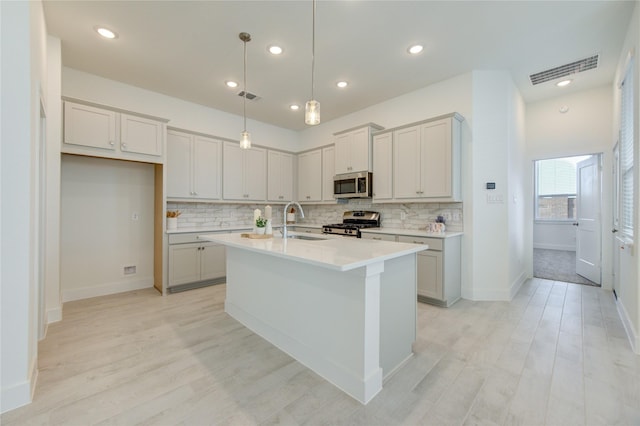 21010 Garden Palm Dr, Cypress, TX 77433 - kitchen featuring stainless steel appliances, backsplash, light wood-type flooring, and recessed lighting