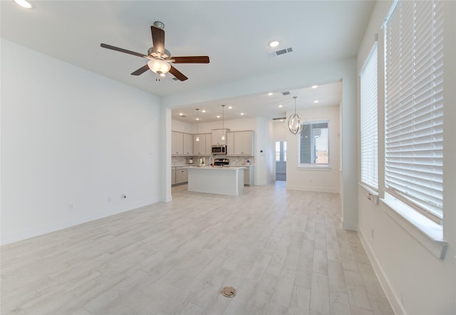 21010 Garden Palm Dr, Cypress, TX 77433 - unfurnished living room featuring light wood-style flooring, plenty of natural light, ceiling fan, and recessed lighting