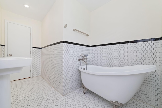 6234 Shadow Crest St, Houston, TX 77074 - full bathroom with a wainscoted wall, tile walls, a freestanding tub, and tile patterned floors