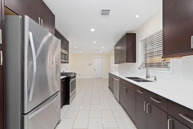 6234 Shadow Crest St, Houston, TX 77074 - kitchen featuring stainless steel appliances, backsplash, light countertops, dark brown cabinets, and recessed lighting