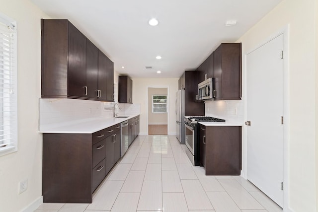 6234 Shadow Crest St, Houston, TX 77074 - kitchen featuring stainless steel appliances, decorative backsplash, light countertops, dark brown cabinets, and recessed lighting