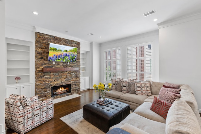 1908 Greenwich Place Dr, Houston, TX 77019 - living room with ornamental molding, built in features, wood finished floors, recessed lighting, and a stone fireplace