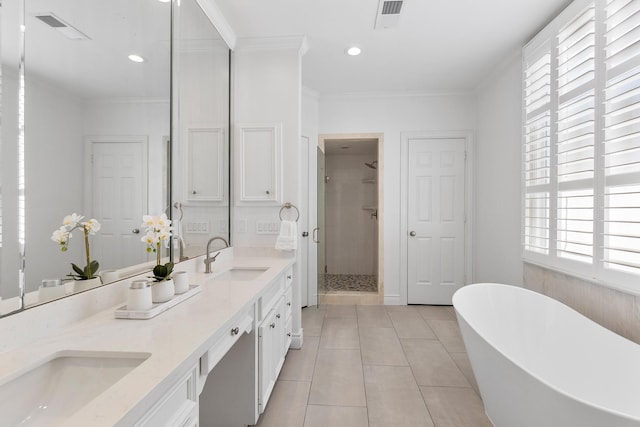 1908 Greenwich Place Dr, Houston, TX 77019 - full bath with a shower stall, a freestanding tub, double vanity, tile patterned floors, and crown molding