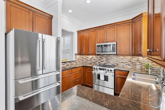 1908 Greenwich Place Dr, Houston, TX 77019 - kitchen featuring high quality appliances, brown cabinetry, tasteful backsplash, ornamental molding, and dark stone countertops