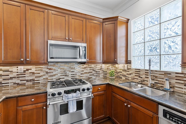 1908 Greenwich Place Dr, Houston, TX 77019 - kitchen with appliances with stainless steel finishes, brown cabinets, decorative backsplash, dark stone countertops, and ornamental molding