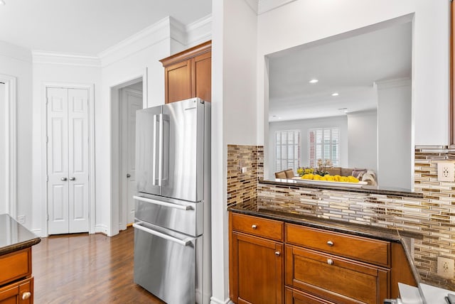 1908 Greenwich Place Dr, Houston, TX 77019 - kitchen featuring freestanding refrigerator, brown cabinetry, crown molding, dark wood-style floors, and decorative backsplash
