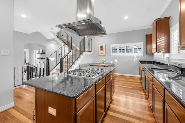 2043 W 14th 1/2 St, Houston, TX 77008 - kitchen featuring range hood, stainless steel gas stovetop, a center island, light wood finished floors, and ornamental molding
