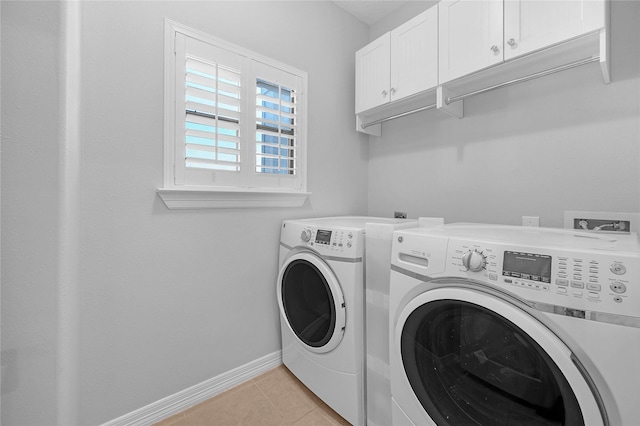 2043 W 14th 1/2 St, Houston, TX 77008 - laundry room featuring washer and dryer, cabinet space, and light tile patterned floors