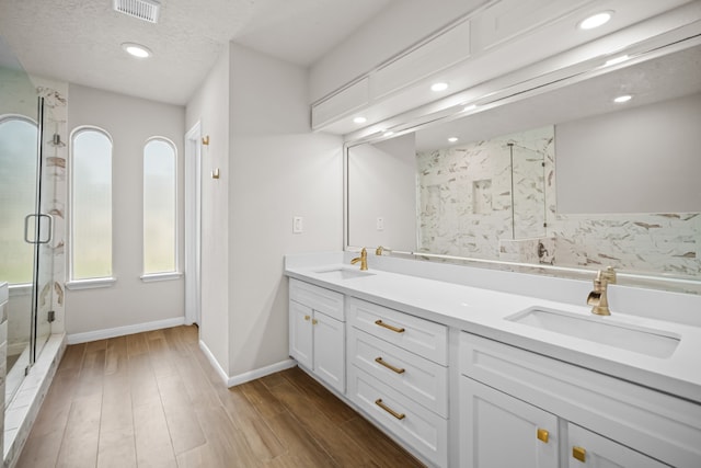 3503 Arbor Terrace Ct, Spring, TX 77388 - bathroom with a shower stall, double vanity, recessed lighting, and wood finished floors