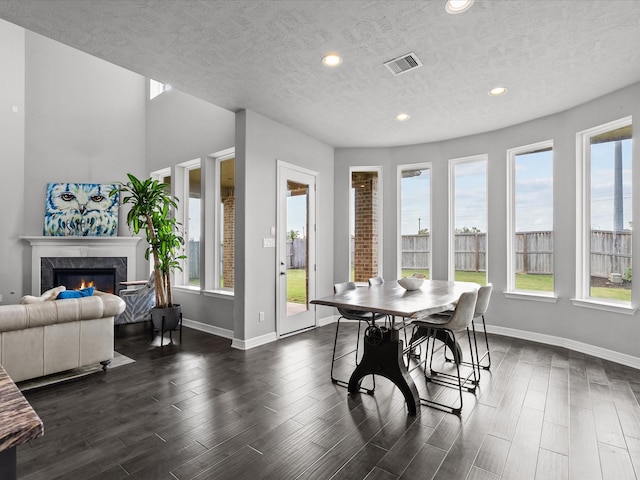 3723 Kerr Commons Ln, Houston, TX 77059 - dining room featuring a textured ceiling, a high end fireplace, recessed lighting, and dark wood-style flooring