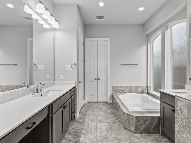 3723 Kerr Commons Ln, Houston, TX 77059 - bathroom featuring vanity, a whirlpool tub, recessed lighting, and marble finish flooring