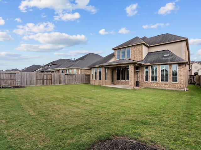3723 Kerr Commons Ln, Houston, TX 77059 - rear view of house featuring a patio, brick siding, a fenced backyard, and a shingled roof