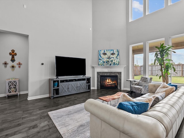 3723 Kerr Commons Ln, Houston, TX 77059 - living area featuring a towering ceiling, a high end fireplace, and dark wood-style flooring