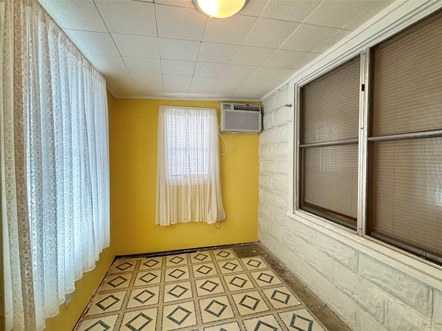 1410 W Pavillion St, Woodville, TX 75979 - unfurnished room with a wall unit AC and baseboards