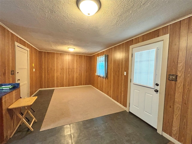 1410 W Pavillion St, Woodville, TX 75979 - entryway with wood walls, a textured ceiling, and ornamental molding