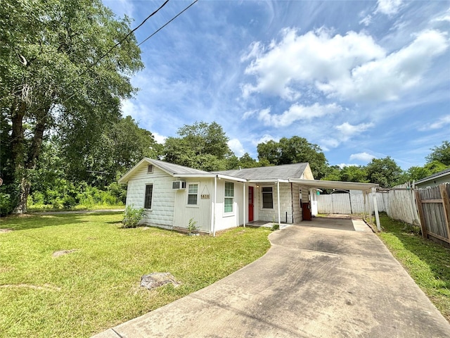 1410 W Pavillion St, Woodville, TX 75979 - view of front of house with an attached carport and driveway
