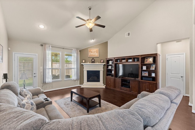 23707 Pennington Hills Dr, Spring, TX 77389 - living area with a ceiling fan, a glass covered fireplace, wood finished floors, and high vaulted ceiling