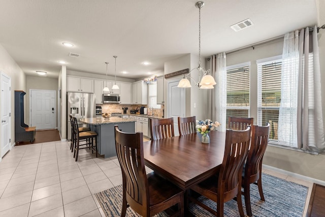 23707 Pennington Hills Dr, Spring, TX 77389 - dining area with a chandelier, light tile patterned floors, and recessed lighting