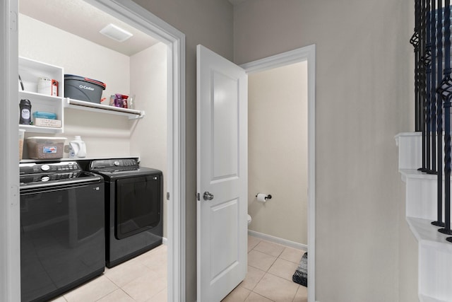 23707 Pennington Hills Dr, Spring, TX 77389 - washroom featuring washer and clothes dryer and light tile patterned floors