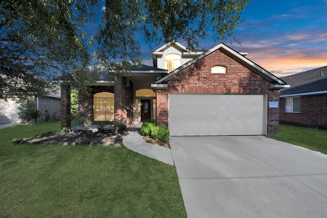 32310 Archer Park, Conroe, TX 77385 - view of front of property with a garage, driveway, brick siding, and a front lawn