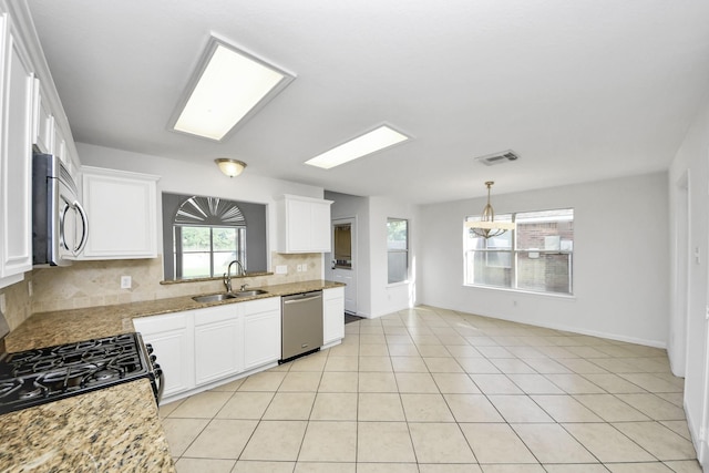 32310 Archer Park, Conroe, TX 77385 - kitchen with stainless steel appliances, decorative backsplash, white cabinets, and light stone countertops