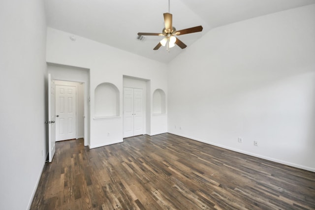 32310 Archer Park, Conroe, TX 77385 - unfurnished bedroom featuring dark wood-type flooring, a closet, a ceiling fan, arched walkways, and high vaulted ceiling