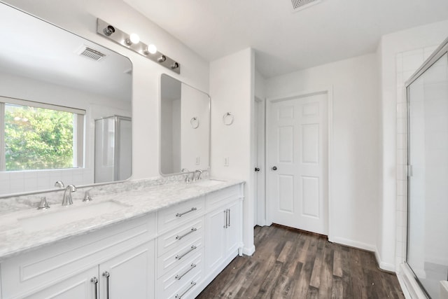 32310 Archer Park, Conroe, TX 77385 - bathroom featuring double vanity, a shower with door, and wood finished floors