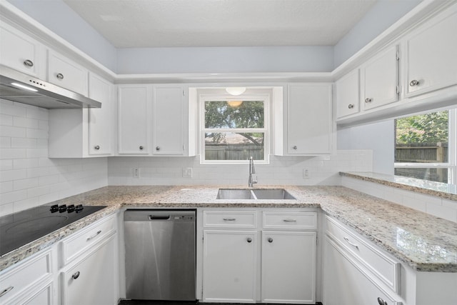 23206 Goodfellow Dr, Spring, TX 77373 - kitchen with stainless steel dishwasher, black electric stovetop, under cabinet range hood, and white cabinetry