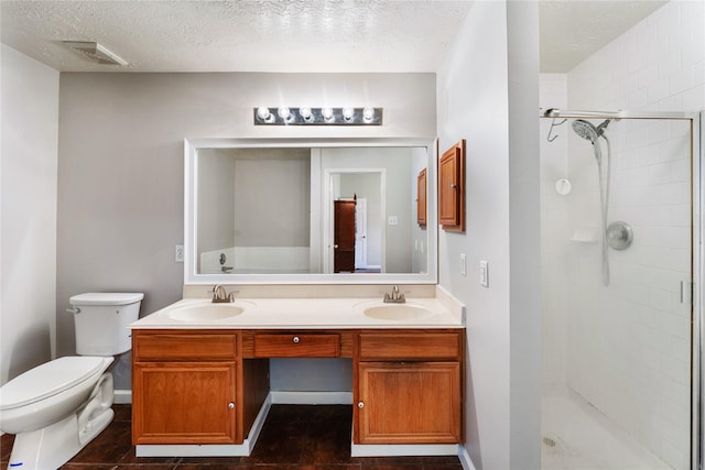 2410 Prides Crossing Rd, Houston, TX 77067 - bathroom featuring double vanity, a shower stall, a textured ceiling, and tile patterned floors